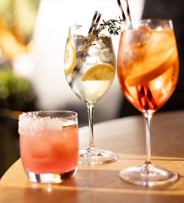 An assortment of drinks arranged on a table with a narrow depth of field.
