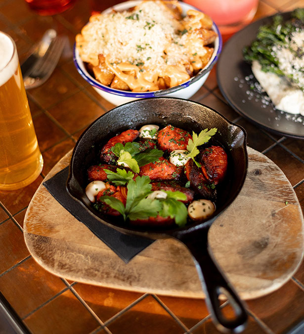 A close view from above looking at a restaurant table showing multiple striking meals arranged on the tabletop.
